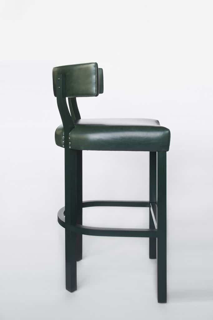 A studio product shot of a dark green bar stool on a white background.