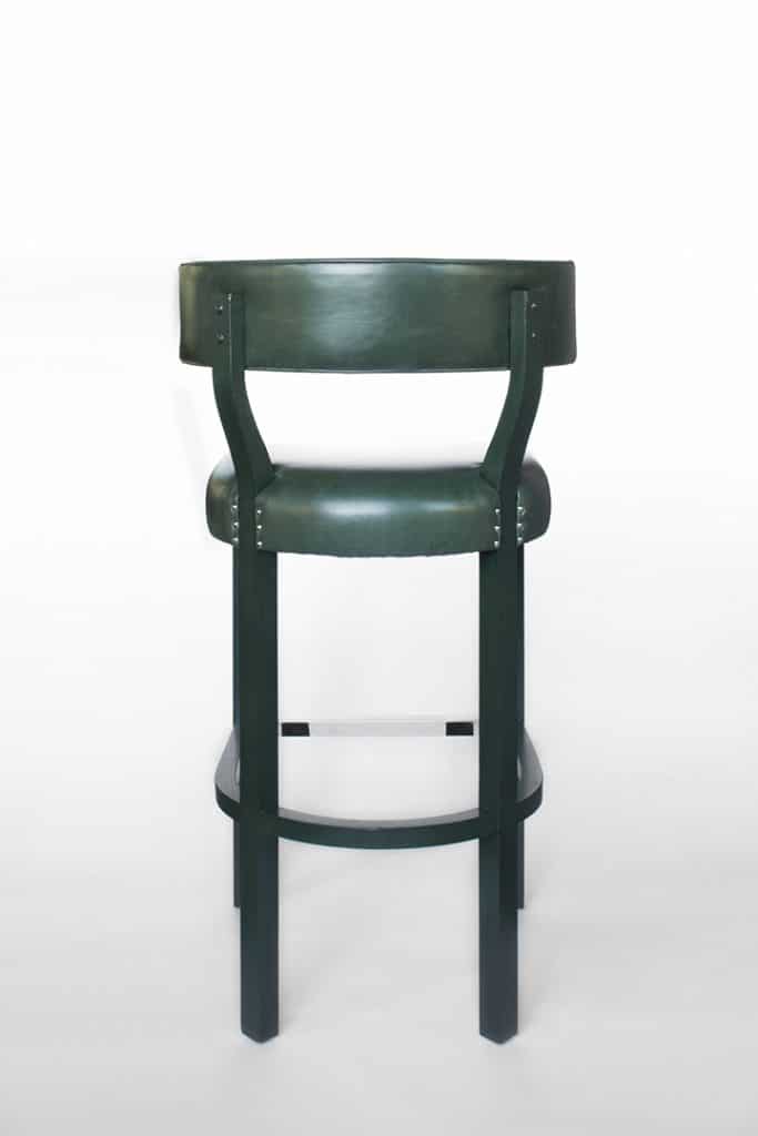A studio product shot of a dark green bar stool on a white background.